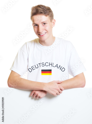 German sports fan standing on a sign board photo