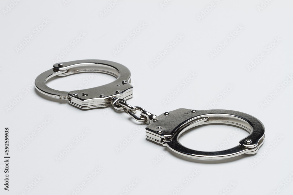 Handcuffs against white background, horizontal Handcuffs against white background, horizontal