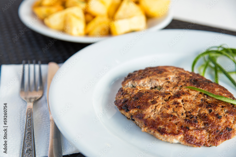 Grilled meat cutlet served