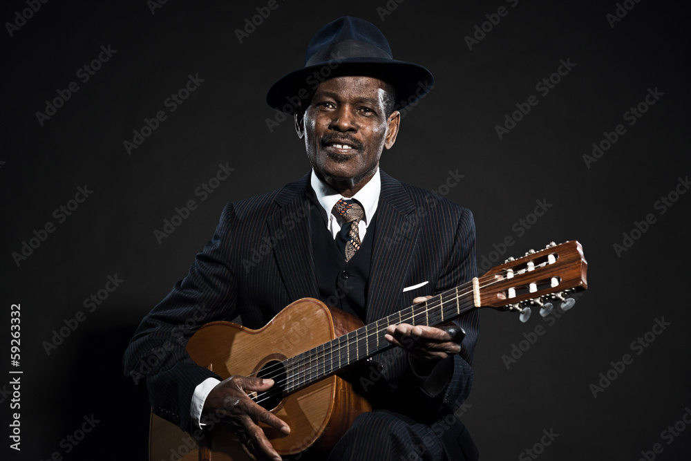 Obraz premium Retro senior afro american blues man. Wearing striped suit with