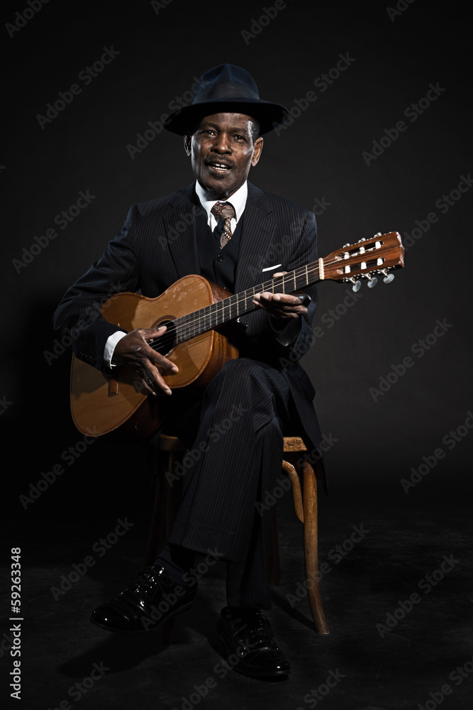Obraz premium Retro senior afro american blues man. Wearing striped suit with