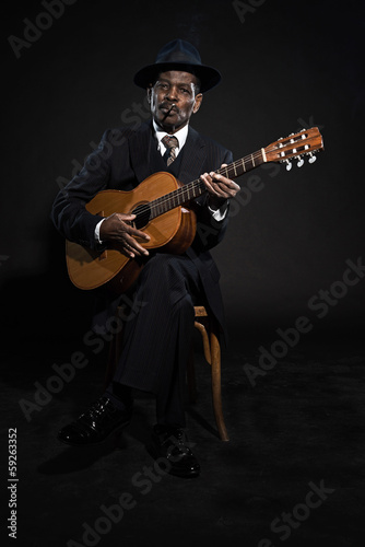 Retro senior afro american blues man. Wearing striped suit with © ysbrandcosijn