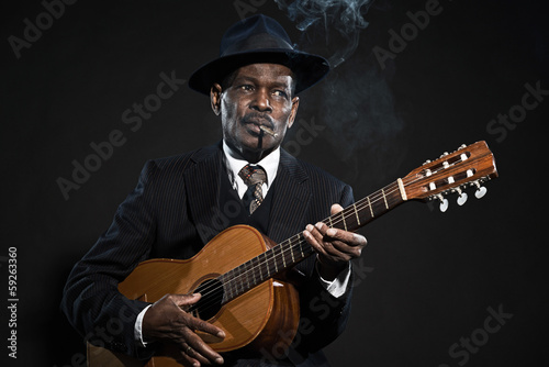 Retro senior afro american blues man. Wearing striped suit with