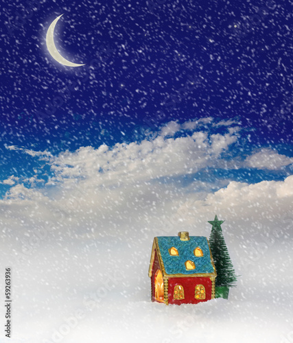 Christmas festive light in house under blue sky © Liliia