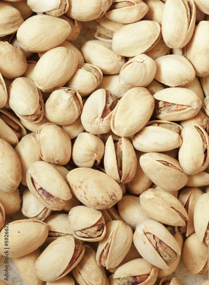 Closeup of pistachios in nut shells as food background