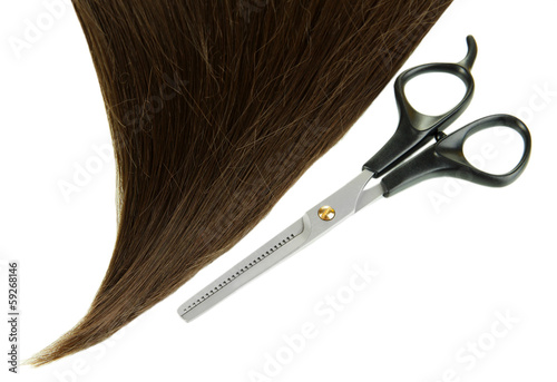 Shiny brown hair with scissors isolated on white