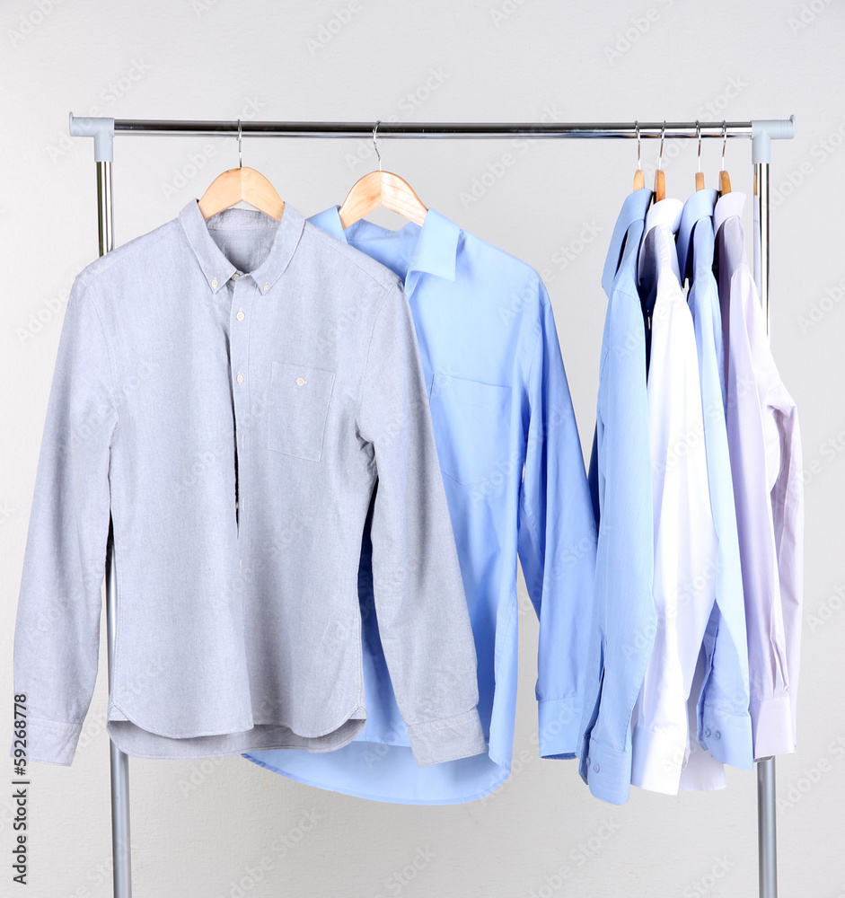Office male clothes on hangers, on gray background Office male clothes on hangers, on gray background