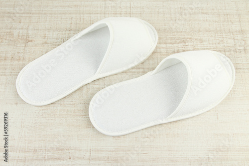 White slippers on wooden background