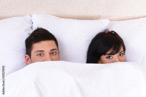 Couple in love sleeping in bed