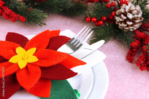 Christmas table setting with festive decorations close up