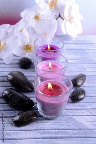 Beautiful colorful candles  spa stones and  orchid flower on