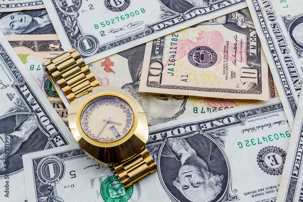 Wristwatch on a heap of paper dollars. Wristwatch on a heap of paper dollars.