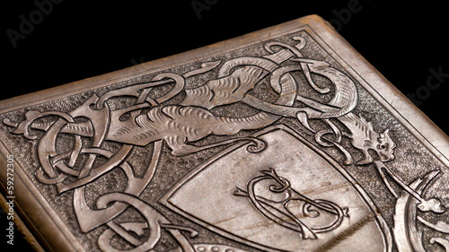 Canvas Print Old leather bound book with a dragon on the cover