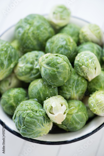 Bowl full of fresh brussels sprouts, vertical shot, close-up