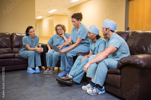 Medical Team Using Digital Tablet In Hospital's Waiting Room