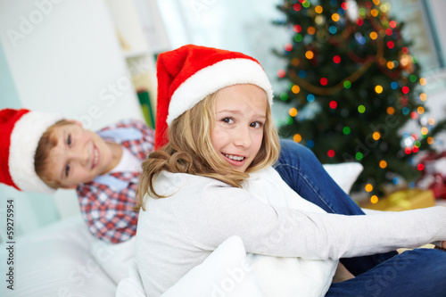 Siblings in Santa caps