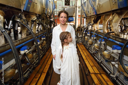 Mother and little daughter in white robes and machines photo