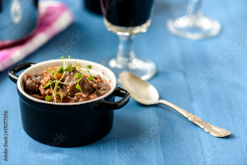boeuf bourguignon classic french beef stew on blue table with a