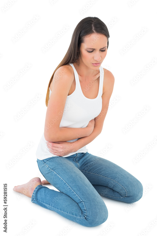 Displeased casual young woman with stomach pain Displeased casual young woman with stomach pain