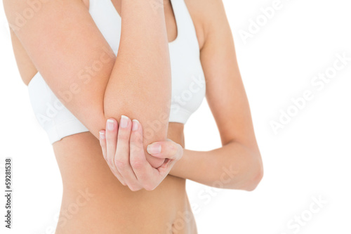 Close-up mid section of a fit woman with elbow pain