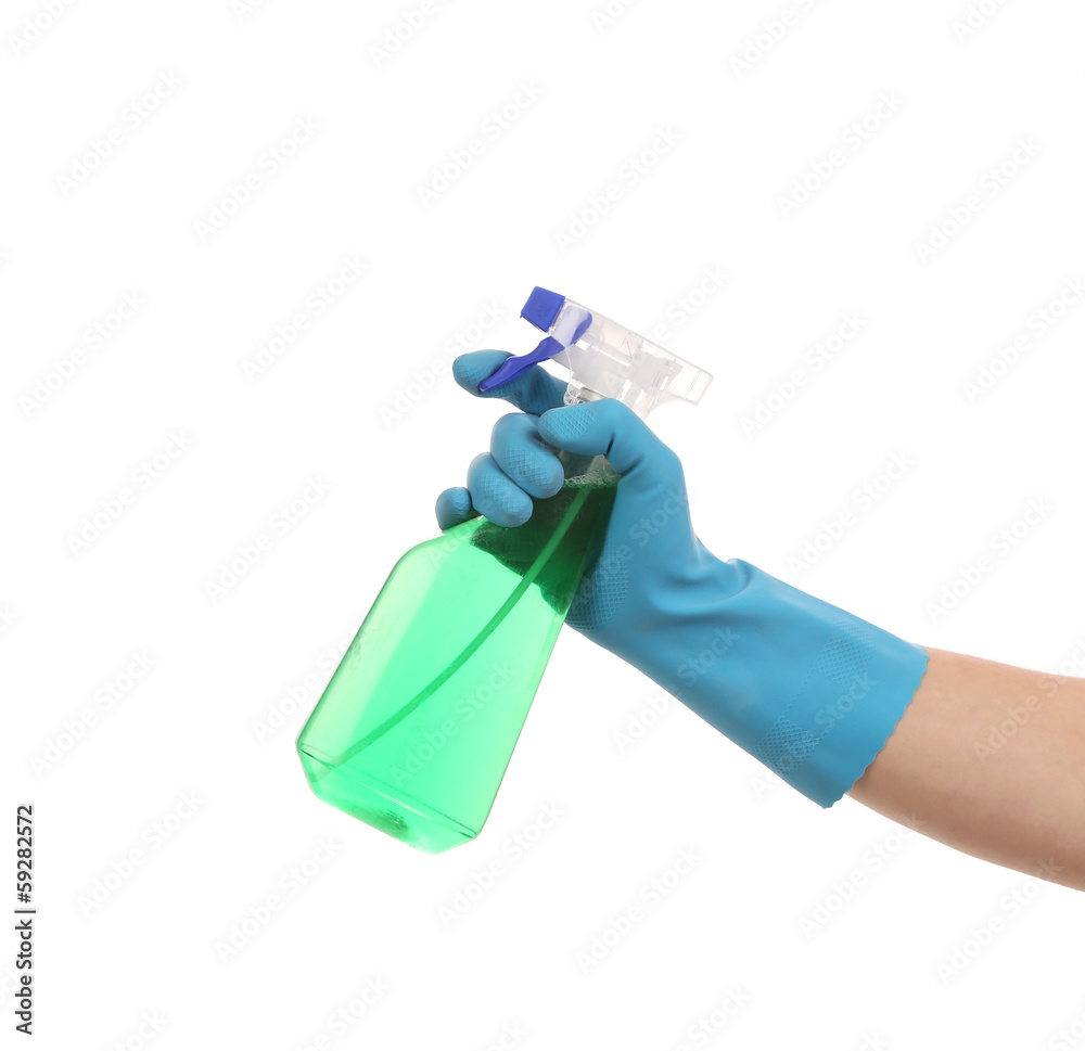 Hand in gloves holds spray bottle.