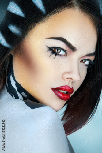 Portrait of fashion model in studio with stripes on hair in stud