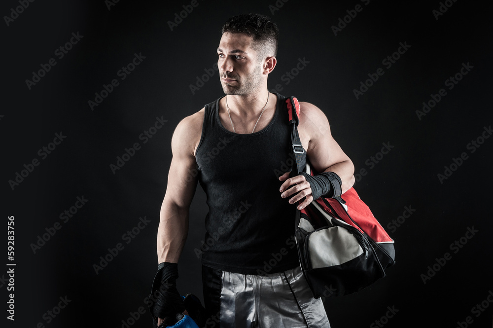 Fototapeta premium Sportsman kick boxer portrait after training against black backg