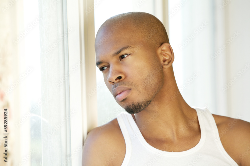 Portrait of a handsome young man looking out of window Portrait of a handsome young man looking out of window