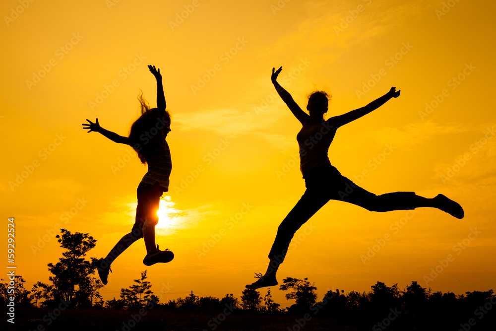mother and daughter jumping on the nature mother and daughter jumping on the nature