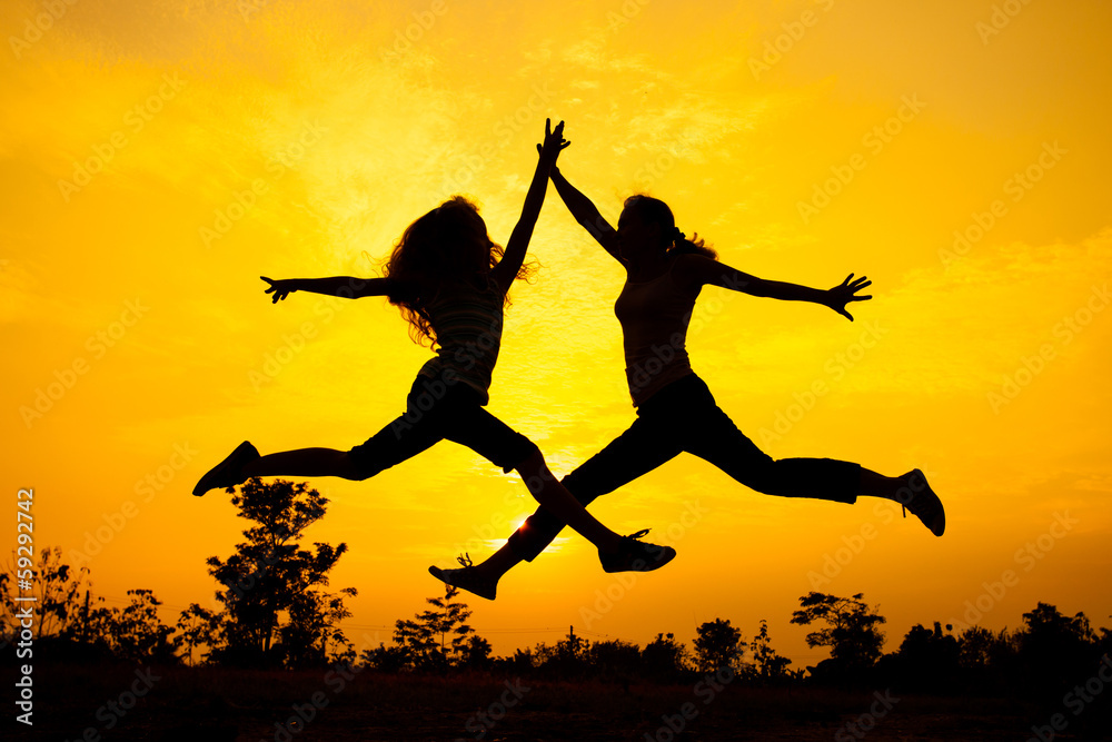 mother and daughter jumping on the nature mother and daughter jumping on the nature