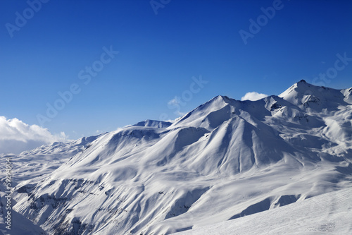 View on ski slope and beautiful mountains at sunny day