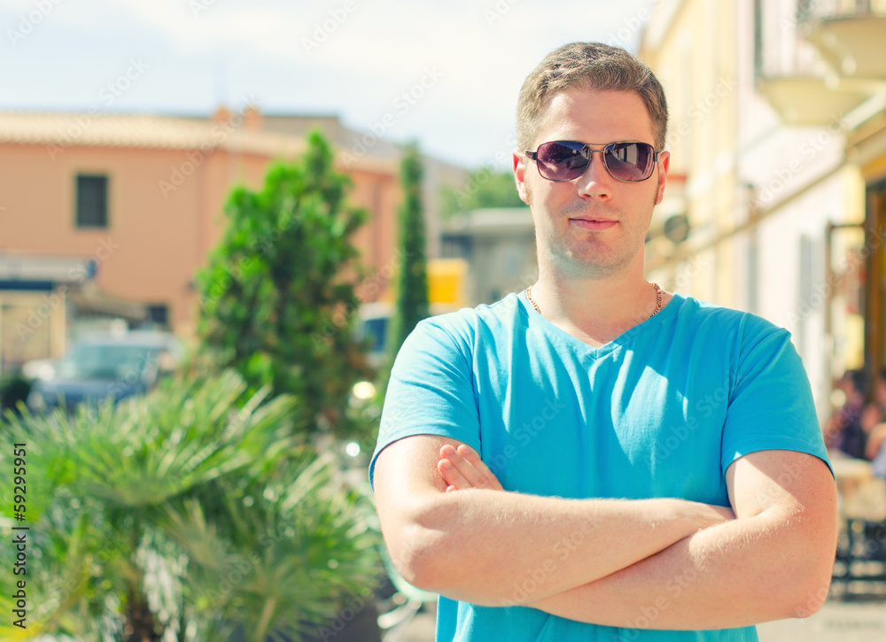 Fototapeta premium Handsome guy portrait on a small town street