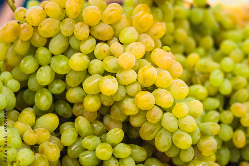 Fresh green grapes pile on the local market. Crop Background Fresh green grapes pile on the local market. Crop Background