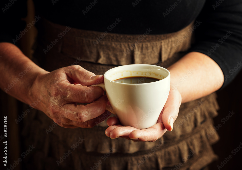 Hands of senior woman holding cup of coffee Hands of senior woman holding cup of coffee