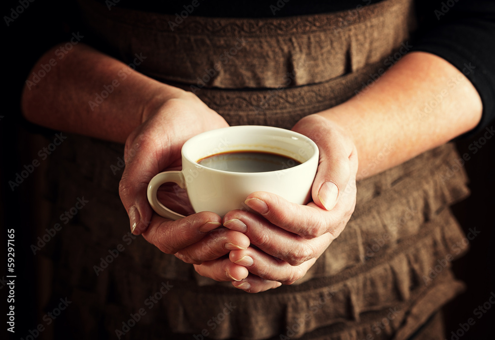 Hands of senior woman holding cup of coffee Hands of senior woman holding cup of coffee