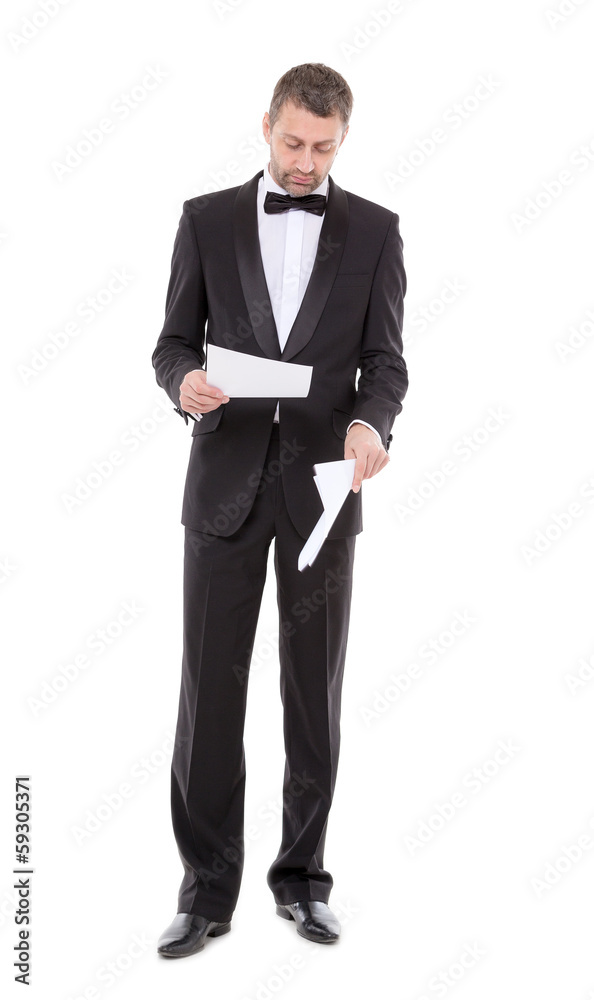 Man in a tuxedo reading the document Man in a tuxedo reading the document