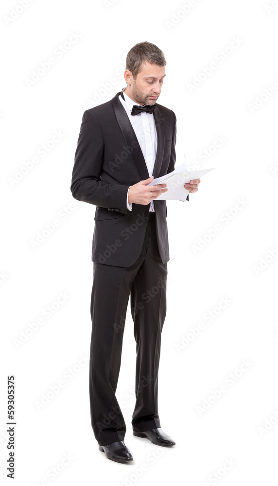 Man in a tuxedo reading the document Man in a tuxedo reading the document