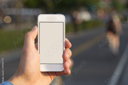 Person using mobile smart phone in the park.