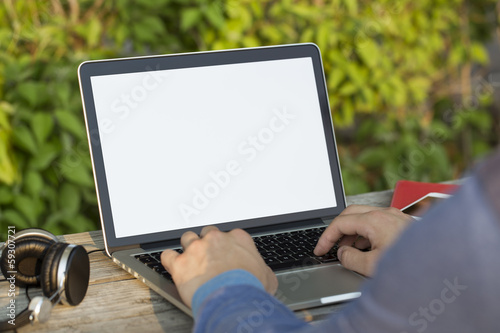 Person working on laptop in a park photo