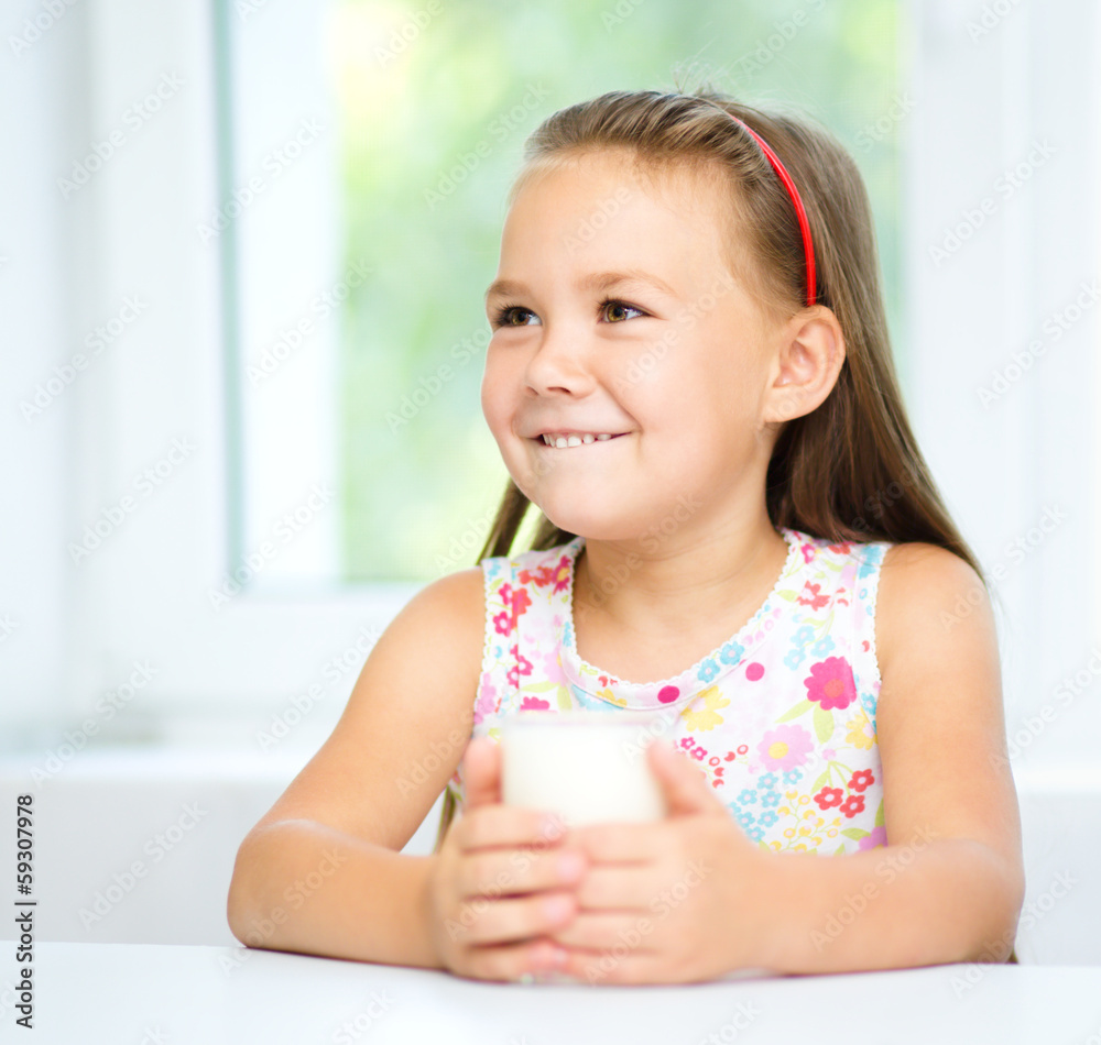 Cute little girl with a glass of milk