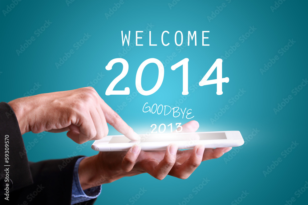 Businessman touching tablet pad for new year 2014