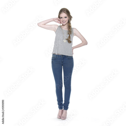 full-length beautiful young woman in jeans a standing