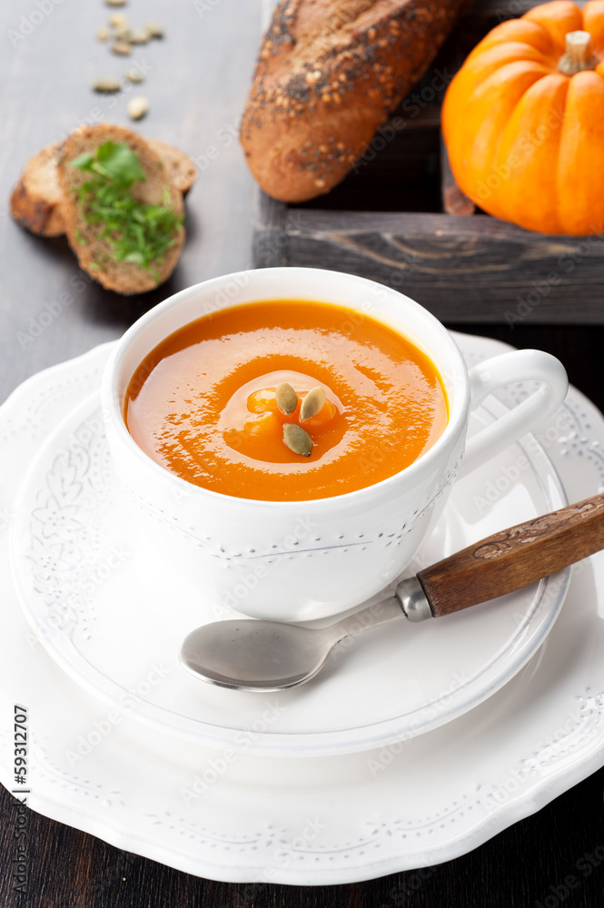 Pumpkin soup with pumpkin seeds, bread, and raw pumpkin Pumpkin soup with pumpkin seeds, bread, and raw pumpkin