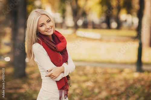 Portrait of very beautiful young woman in autumn park