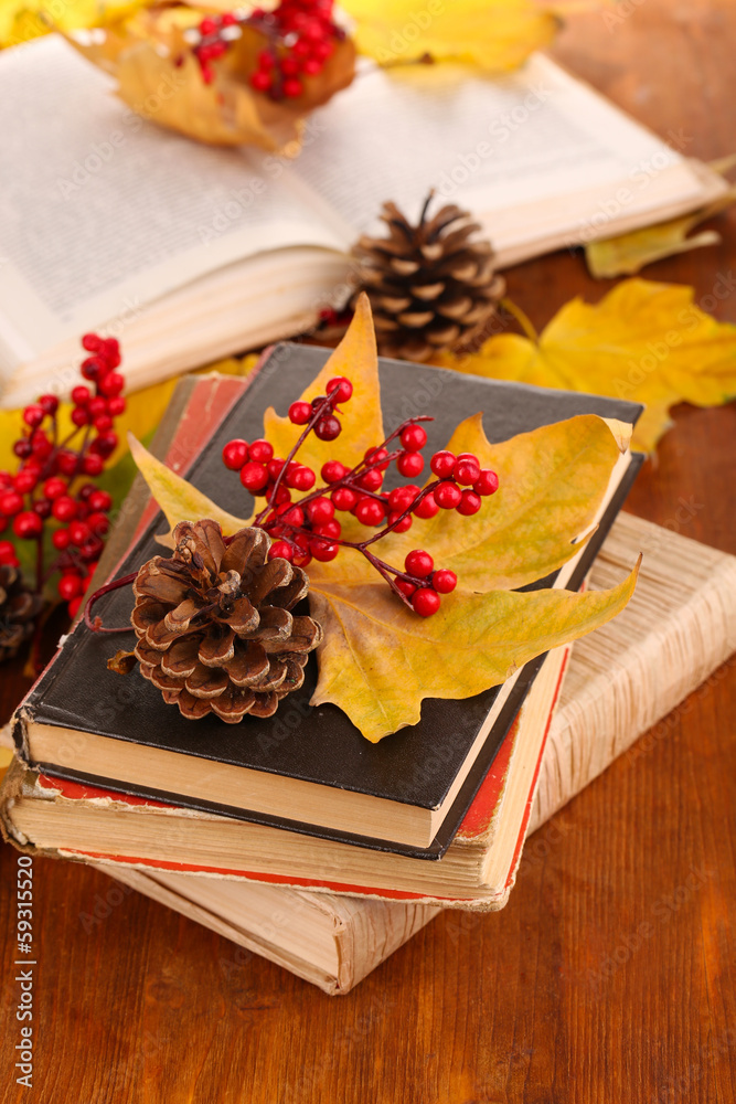 Books and autumn leaves on wooden table close-up Books and autumn leaves on wooden table close-up