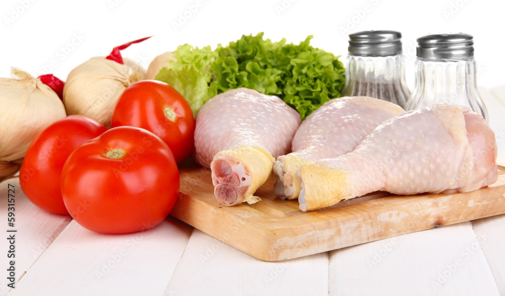 Raw chicken legs on wooden board close up Raw chicken legs on wooden board close up