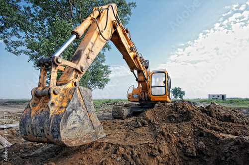 excavator digs a hole photo