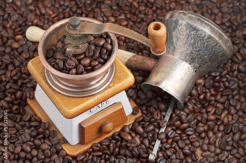 retro manual coffee mill on roasted beans