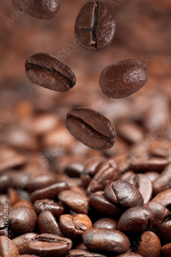 few falling beans and dark roasted coffee