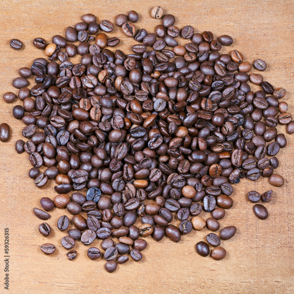 coffee beans on wooden board coffee beans on wooden board